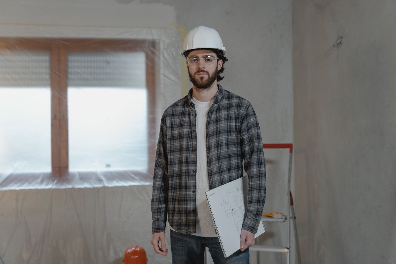 Homeowner reviewing renovation budget and floor plans on a laptop