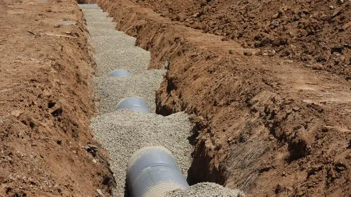 Perforated drainage pipe laid in a gravel trench