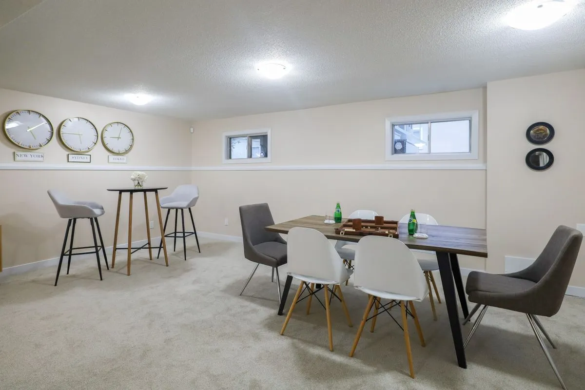 Finished basement dining and living area with small high windows