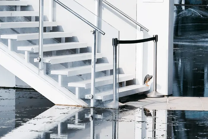 Standing water on a floor beside a staircase